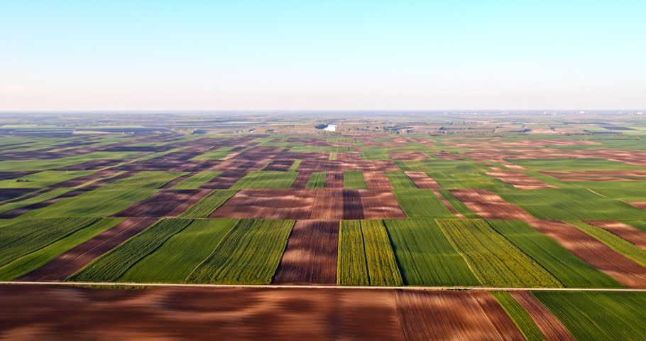 High flight above a colorful patchwork of agricultural fields and cultivated land in springtime