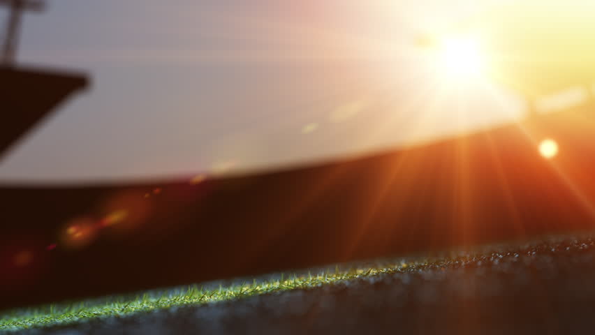 Glowing soccer ball on field at sunset