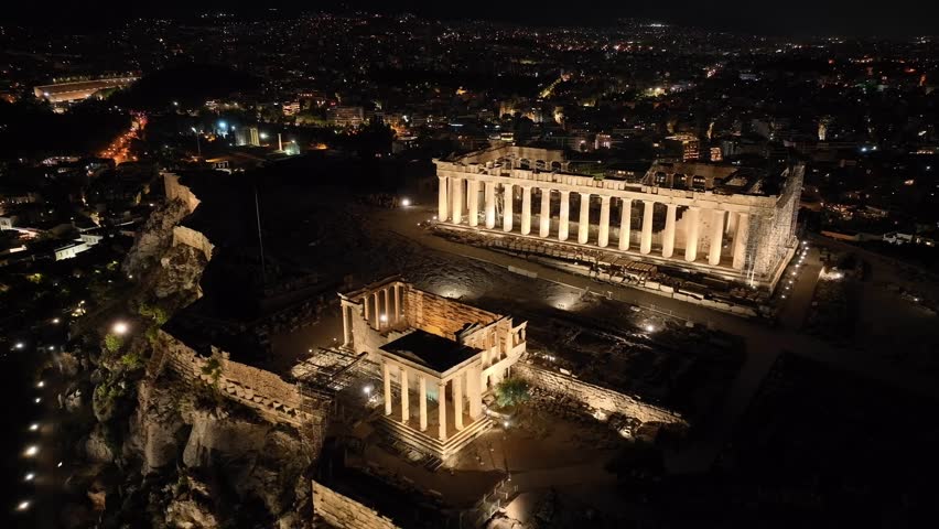 Aerial drone cinematic night video of iconic Acropolis hill and the Parthenon, Athens historic centre, Attica, Greece