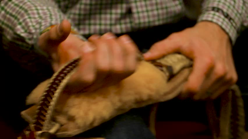 Cowboy preparing gear for bull riding