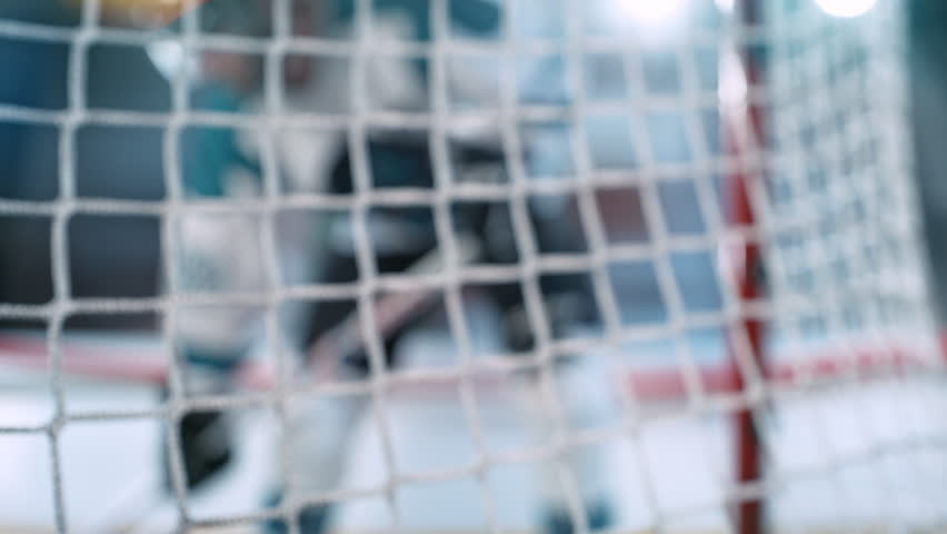 Super Slow Motion Hockey Goal at Professional Ice Arena. Puck Hitting Net at 1000fps