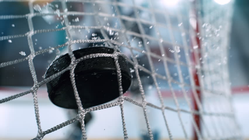 Super Slow Motion Hockey Goal at Professional Ice Arena. Puck Hitting Net at 1000fps