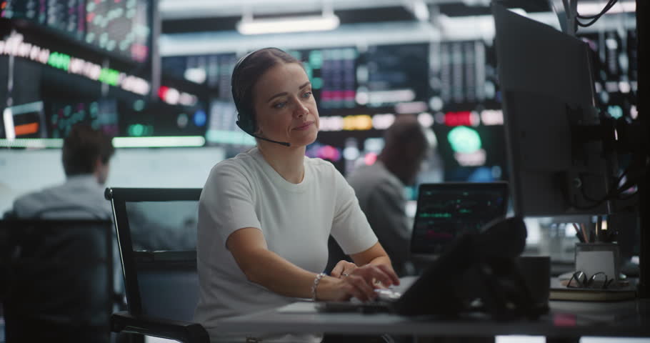 Distressed Female Trader Calling on Desk Phone During Sudden Stock Market Crash. Woman Shock and Despair as Watches Rapid Downward Spiral of Chart on Monitors. Market Collapse, Urgent Intervention.