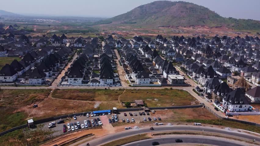 High angle view of a large and wealthy suburban neighborhood with a beautiful mountainous landscape in the background in Abuja, Nigeria