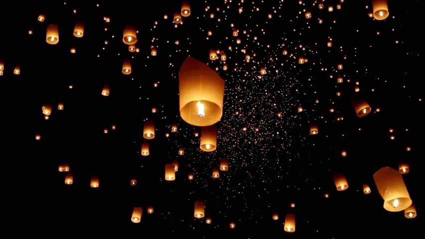 Enchanting Sky Lanterns at Yi Peng Festival, thousands of floating fire paper lanterns in the night sky Chiang Mai Province, Northern Thailand, Asia.