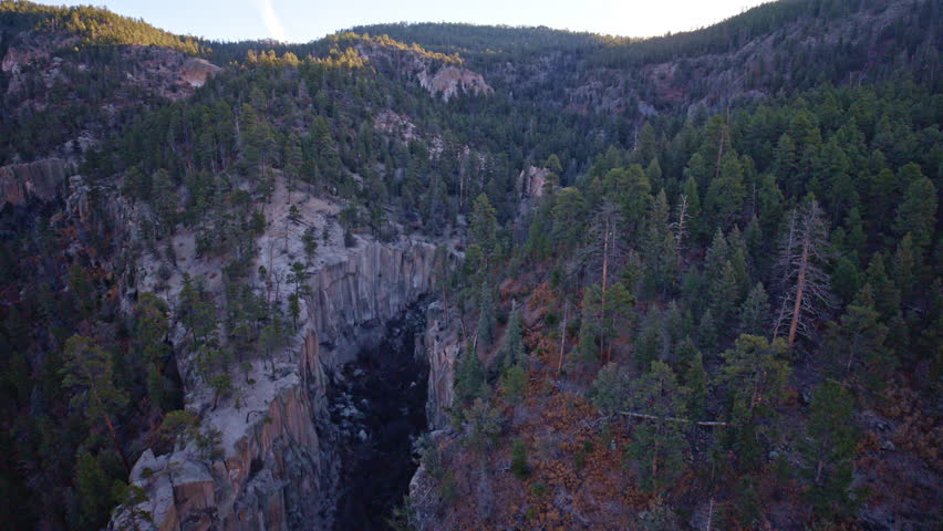 Cinematic drone footage of rugged terrain and cliffs near Los Alamos NM