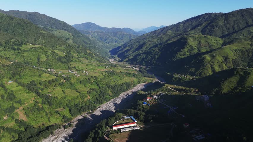 Breathtaking aerial views of Nepal’s mountainous terrain, showcasing highland valleys, rugged peaks, and serene natural landscapes that define the Himalayan region.