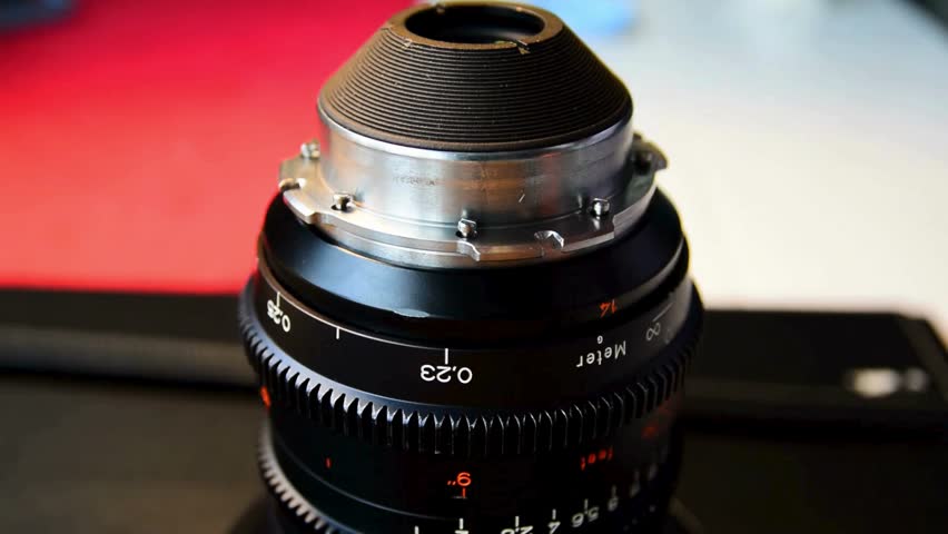 Photographer hand changing manual aperture ring on the camera lens. Lens camera manual focus. Changing exposure with aperture ring on manual lens.