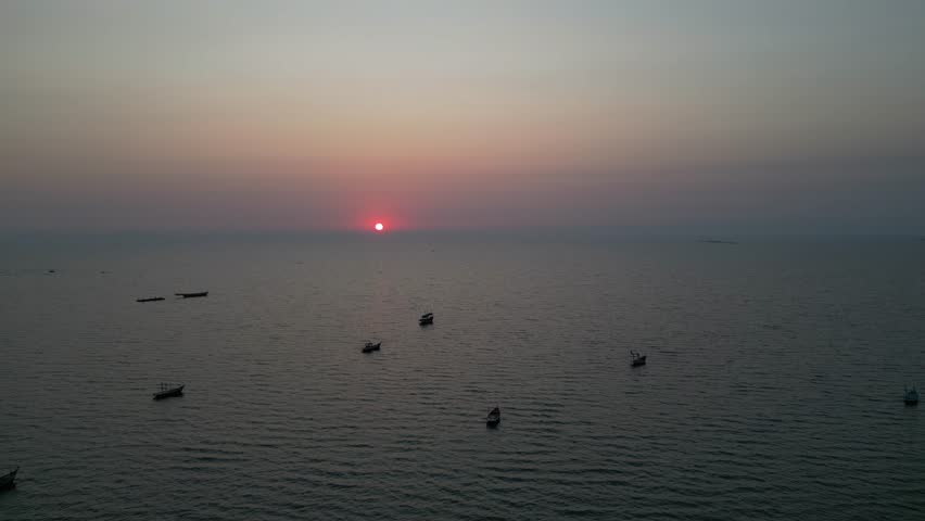 Title: Traditional Fishing Boats Anchored in Golden Sunset Glow at Bang Saen Beach, Thailand
