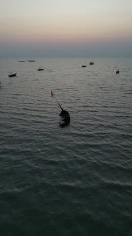 Title: Traditional Fishing Boats Anchored in Golden Sunset Glow at Bang Saen Beach, Thailand
