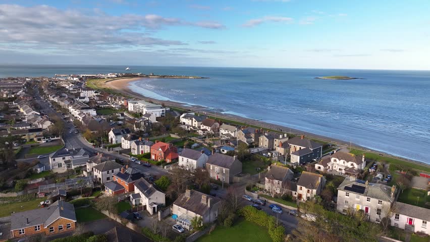 Main street in Skerries Town with light traffic, drone coastal landscape. Ireland