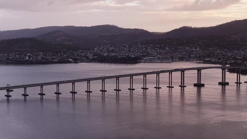 Wharf of Hobart city harbour sullivans cove in aerial flying back from waterfront.