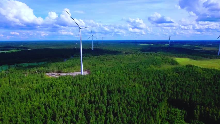 Aerial View of Expansive Forest and Wind Turbines in a Lush Green Landscape Under Blue Skies in Finland