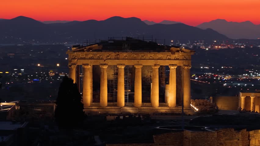 Aerial close-up view of the illuminated Parthenon Temple at the Acropolis of Athens, Greece, during evening time