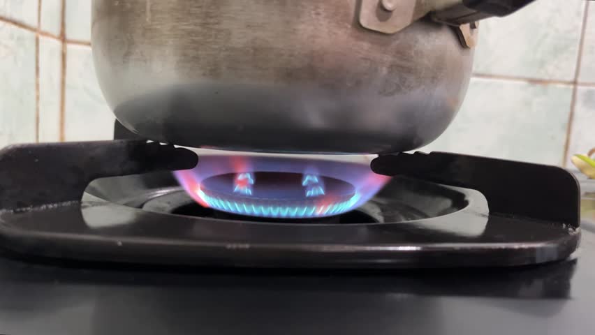 Black Gas Stove with Flame Cooking in Pot, Front View, Kitchen Cooking Concept