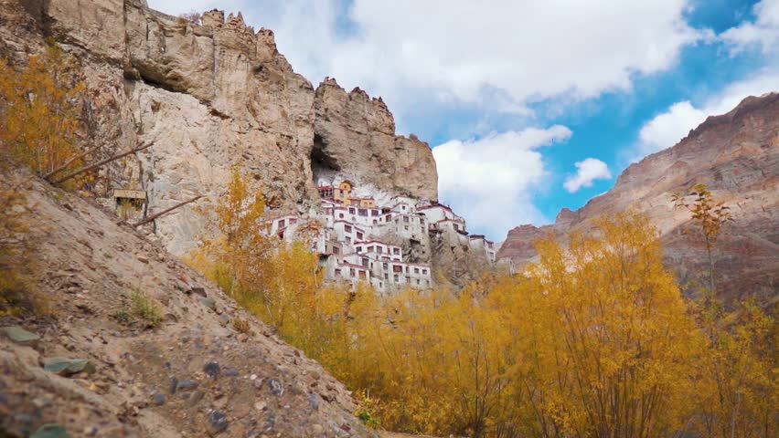 Beautiful landscape of Phugtal monastery in remote Himalayan mountains with autumn trees. Ancient Tibetan Buddhist Phuktal monastery of on a steep rocky mountain in Zanskar, Ladakh, India.  