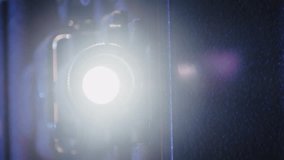 Close-up of an antique 8mm film projector during a home movie screening. Warm diffuse light beam cuts through the air, creating a magical retro atmosphere of analog filmmaking 4K. - Powered by Shutterstock - Get 15% off with code: PIKWIZARD15