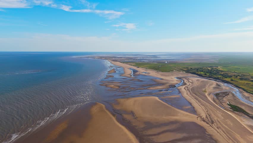 English Coastal Scene. Wide beaches Lincolnshire coast. Aerial video footage showing the north sea and east coast. Gibraltar Point National Nature Reserve near Skegness. Natural untouched landscape.