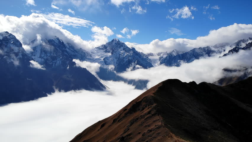 Serene Alpine Landscape Displaying Snowcapped Summits And Extensive Sky Adorned With Clouds. Media