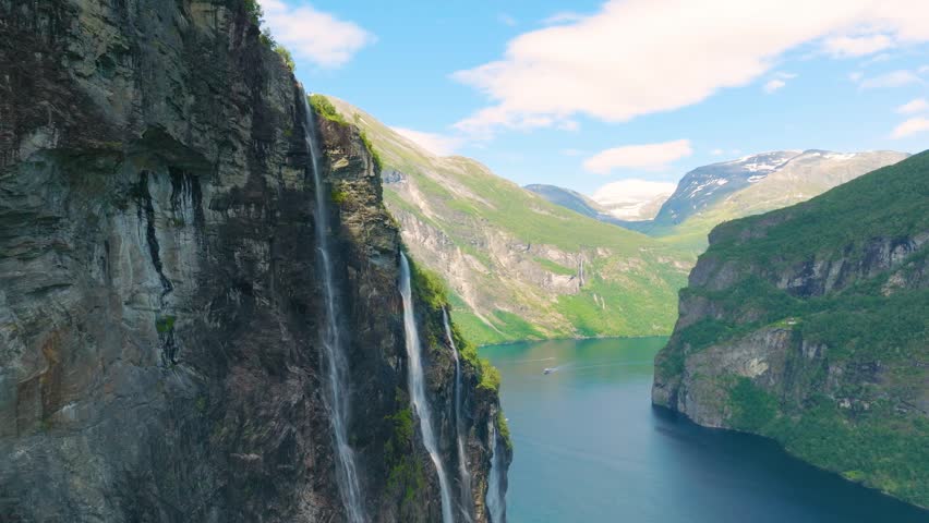 Seven Sisters Waterfall, Geiranger Fjord, Norway. Nature in fjords. Traveling through the Norwegian fjords. Scandinavia. View of nature from the drone. Vacation and travel in summer Norway.