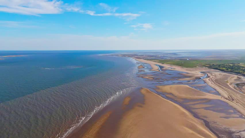 English Coastal Scene. Wide beaches Lincolnshire coast. Aerial video footage showing the north sea and east coast. Gibraltar Point National Nature Reserve near Skegness. Natural untouched landscape.
