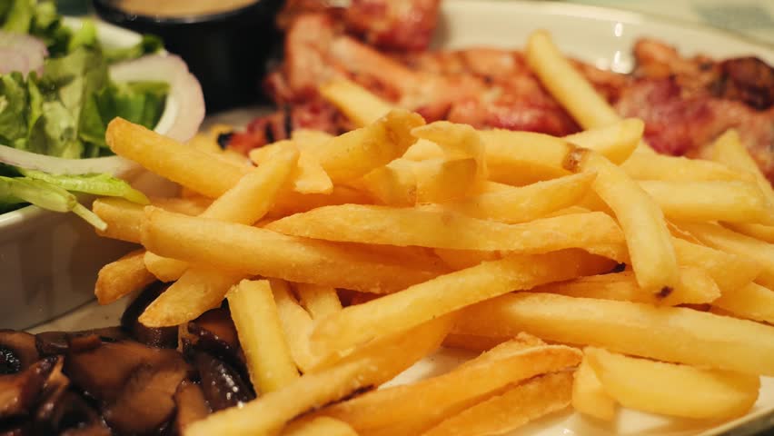 Fried chicken breast with French fries and salad, homemade mustard.