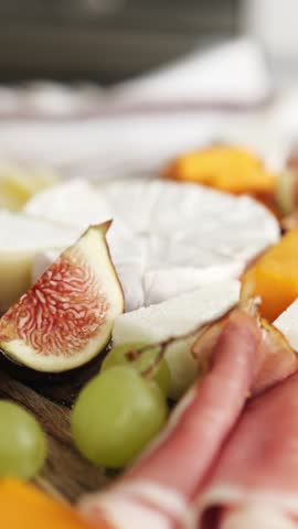 Cheese Board With Fruits And Ham On A Table An Appetizing Dish, Vertical Video
