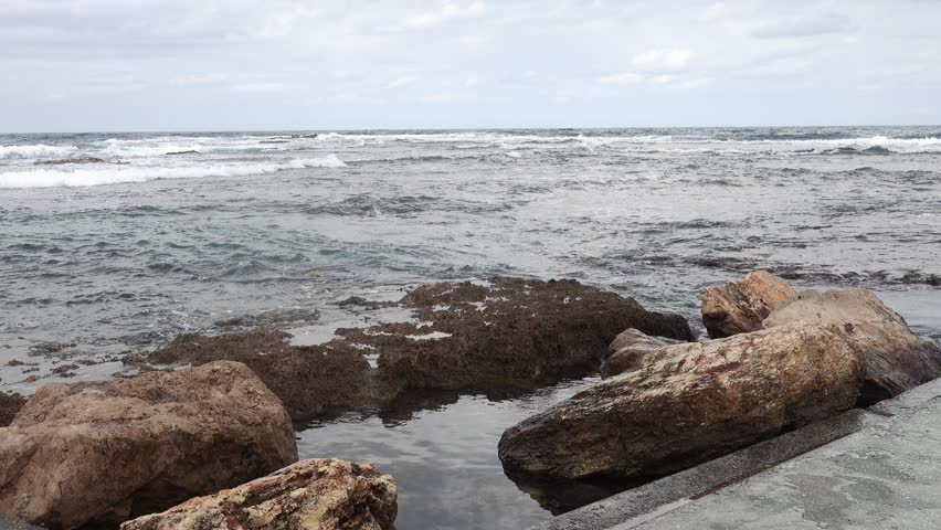 Rocky Seashore With Waves And Cloudy Sky Coastal Landscape