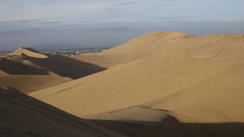 Huacachina, Peru. Sand dunes oasis of Huacachina desert. Golden ripples, arid landscape, Peru, natural patterns, dry terrain, travel destination, South America, scenic view wind-shaped dunes
