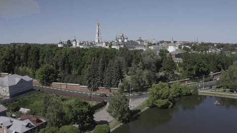 Drone Rising Forward toward Monastery over Trees