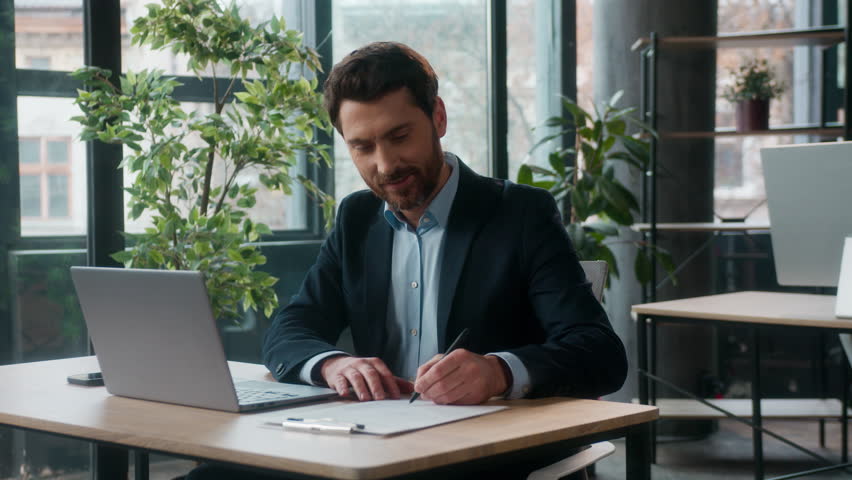 Successful Caucasian businessman manager typing laptop writing notes in office professional male accountant entrepreneur leader write data accounting work developer employer business man guy working