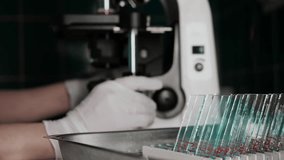 Close up of laboratory technician using microscope with glass slides for scientific research and diagnostic analysis in laboratory environment. - Powered by Shutterstock - Get 15% off with code: PIKWIZARD15