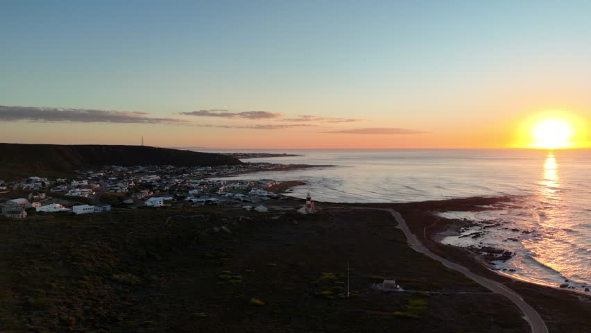 Peaceful South African Seaside Village. Golden Sunset Over Rocky Shoreline With Peaceful Dwellings