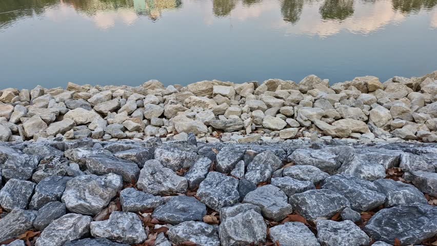 A peaceful park with rocks and water, captured during the fresh morning hours.