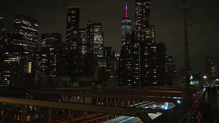 Lower Manhattan skyline night with bridge structure New York