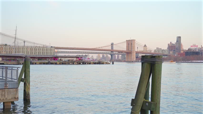 East River winter view with Brooklyn Bridge skyline and pier post