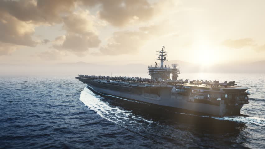 Aircraft Carrier Sailing at Sunset with Fighter Jets on Deck