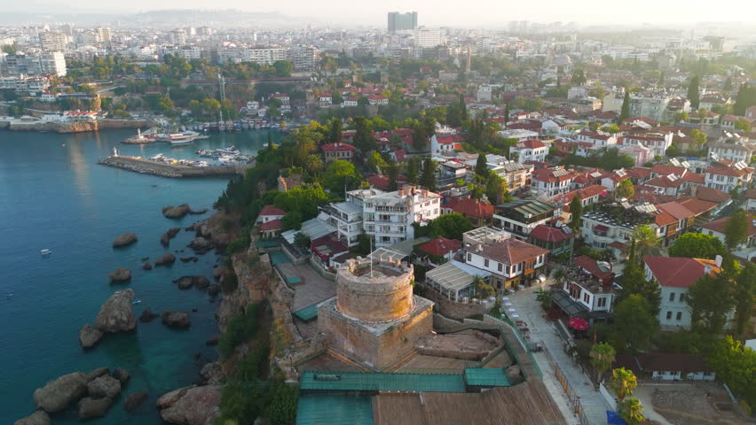 Antalya, Turkey. Aerial view of Hidirlik Tower within Karaalioglu Park landscape with green trees and walking paths in morning light. Aerial View, MasterShots, Spiral forward