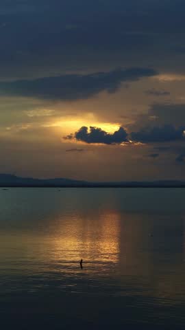 Sunset Over Calm Lake Water