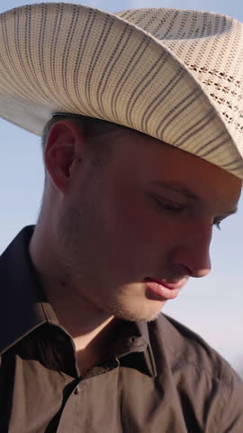 Young cowboy look up towards the sunlight