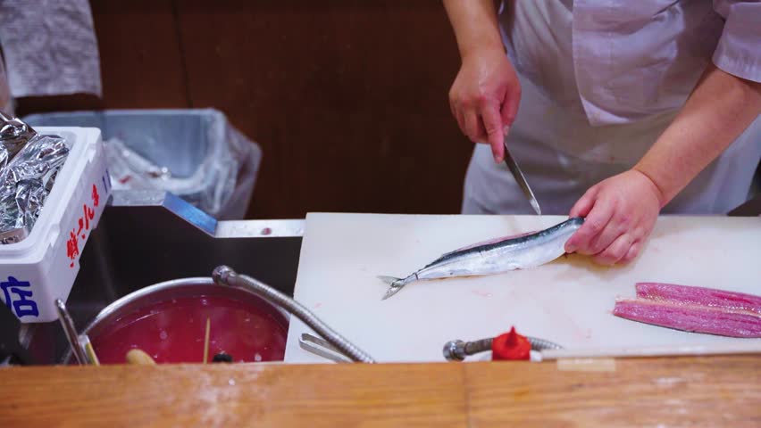 Sushi Chef Preparing Sashimi with Pacific Saury (Sanma) for Omakase Course Meal