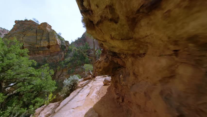 Scenic footage from the popular Canyon Overlook Trail in Zion National Park, Utah. This short, family-friendly hike leads to a stunning viewpoint above the Zion-Mt. Carmel Tunnel, showcasing the majes