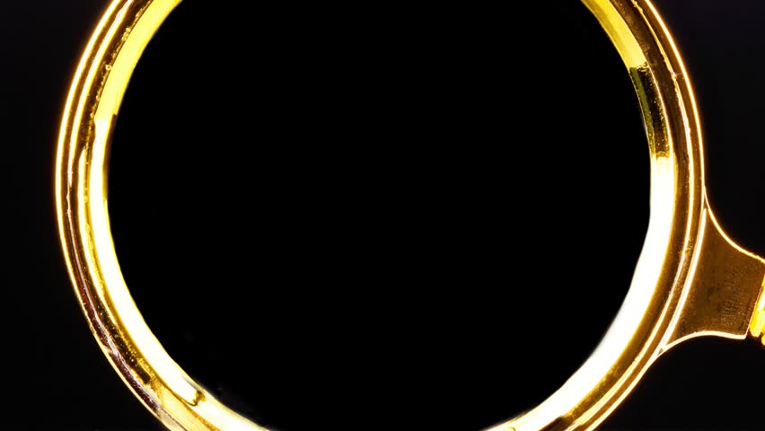 Animated WORK IN PROGRESS text, viewed through a magnifying glass with a gold rim and red handle, against a black background