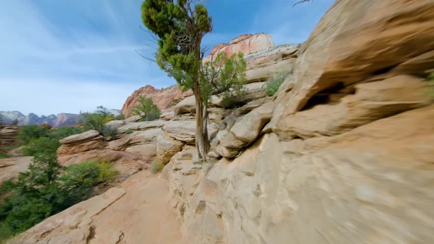 Footage capturing the experience of hiking the Canyon Overlook Trail in Zion National Park, Utah. This popular, relatively easy 1-mile round-trip trail winds along stunning sandstone cliffs and offers
