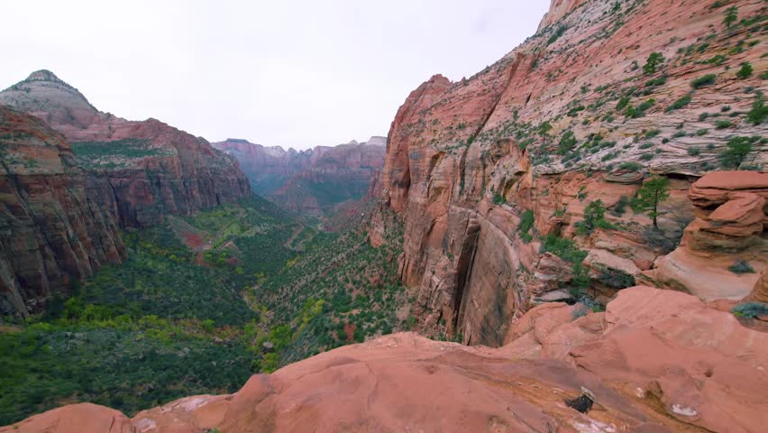 Footage captures the breathtaking, panoramic views from the Canyon Overlook Trail in Zion National Park, Utah. This popular, short hike leads hikers 1,000 feet above the canyon floor and offers dramat