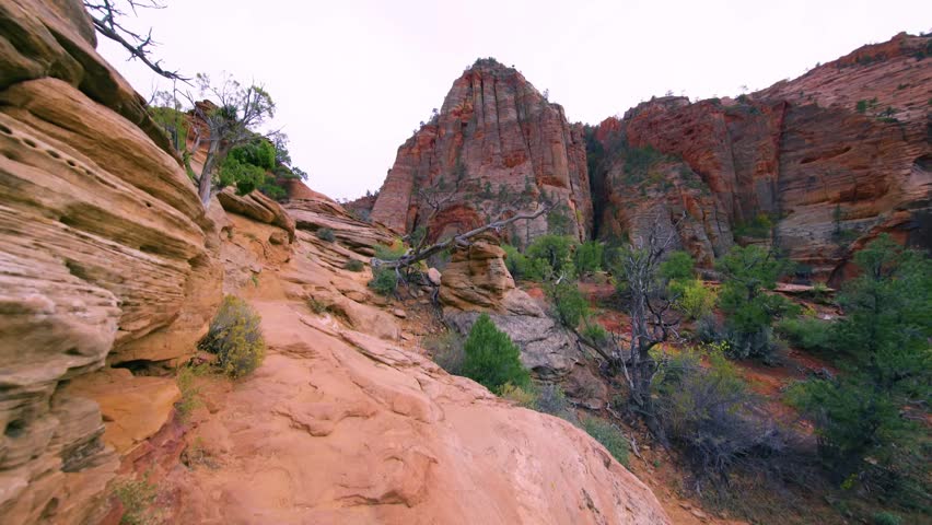 Footage of the scenic Canyon Overlook Trail, a popular and relatively short hike in Zion National Park, Utah, USA. The trail, which starts just east of the Zion-Mount Carmel Tunnel, features stone ste