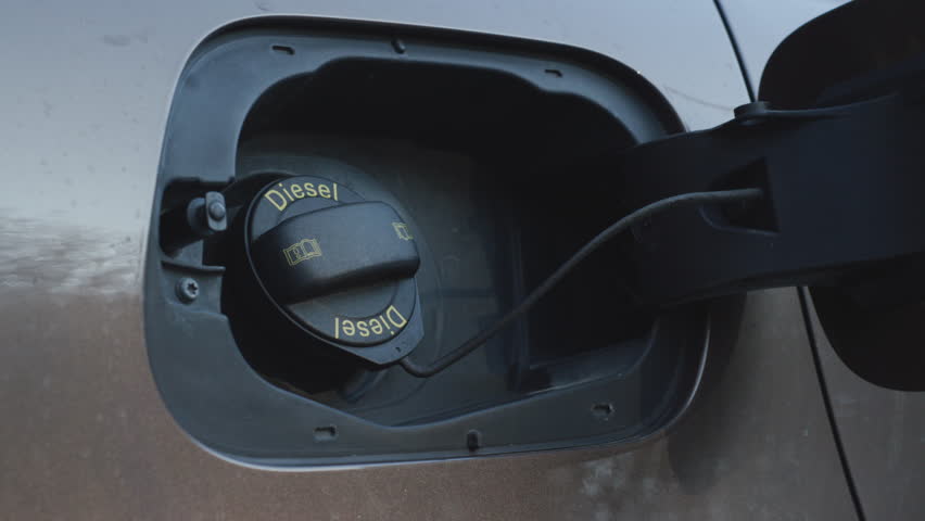 Person closing diesel car fuel tank cap