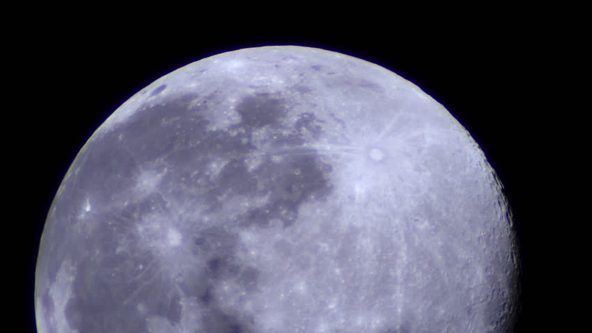 The Moon in a telephoto close-up. The Moon in real time shows visible halation created by the telescope and strong vibrations caused by the air.