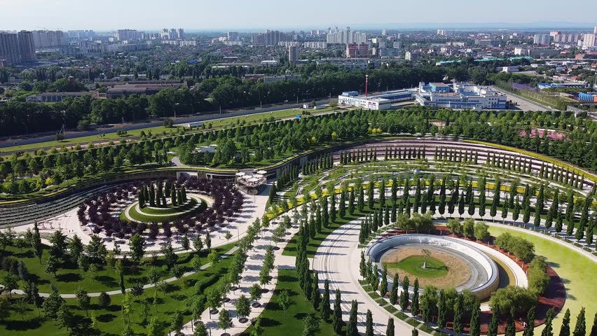 Stunning aerial footage of the modern galitsky public park in krasnodar, featuring unique landscape design with green lawns and trees
