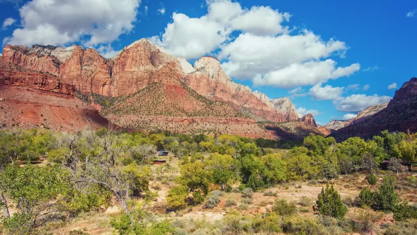 Scenic footage of the rugged red rock formations and towering canyon walls of Zion National Park, Utah, USA, as seen from the moderately difficult Watchman Trail overlook.